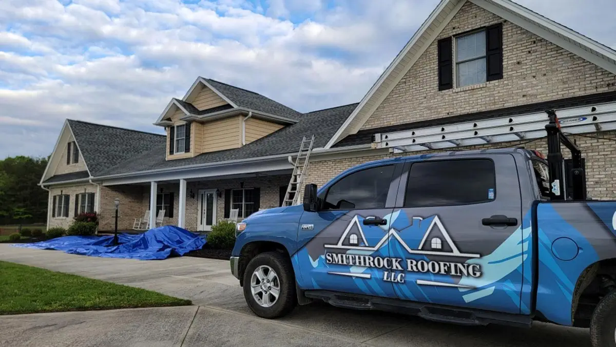 Smithrock Roofing truck parked in front of an active roof replacement project in Winston-Salem, NC