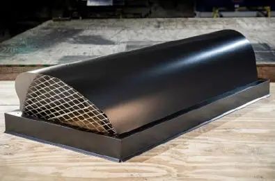 Rounded Stage Coach style chimney cap with dark finish and mesh guard