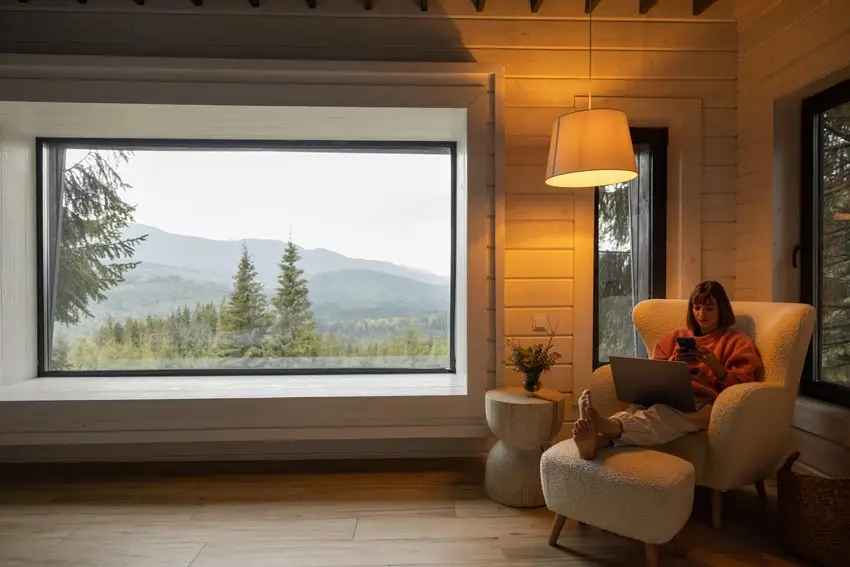 Large picture window with mountain view in cozy living room