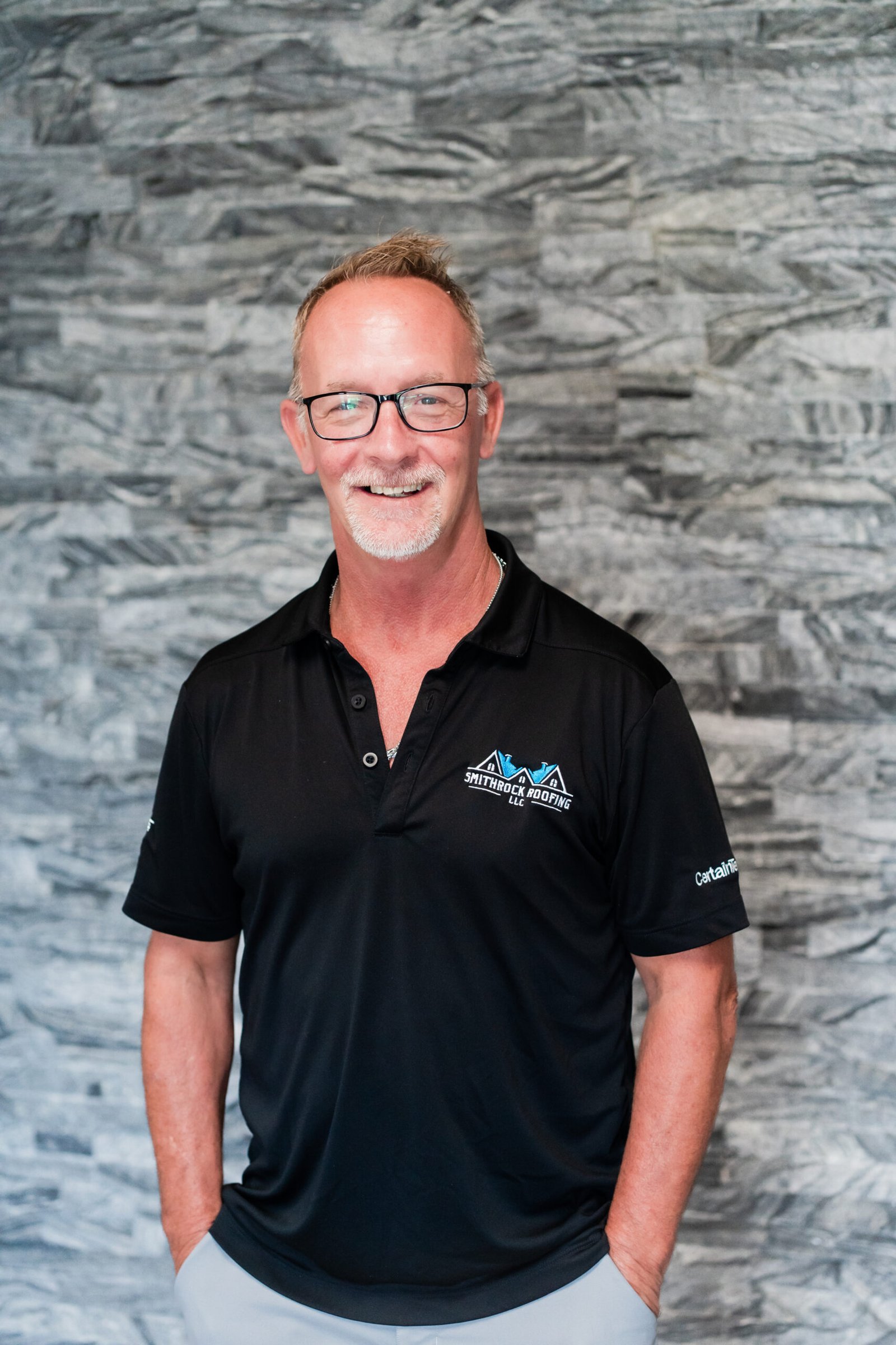 Shane Smith, Roof Specialist at Smithrock Roofing, wearing company gear
