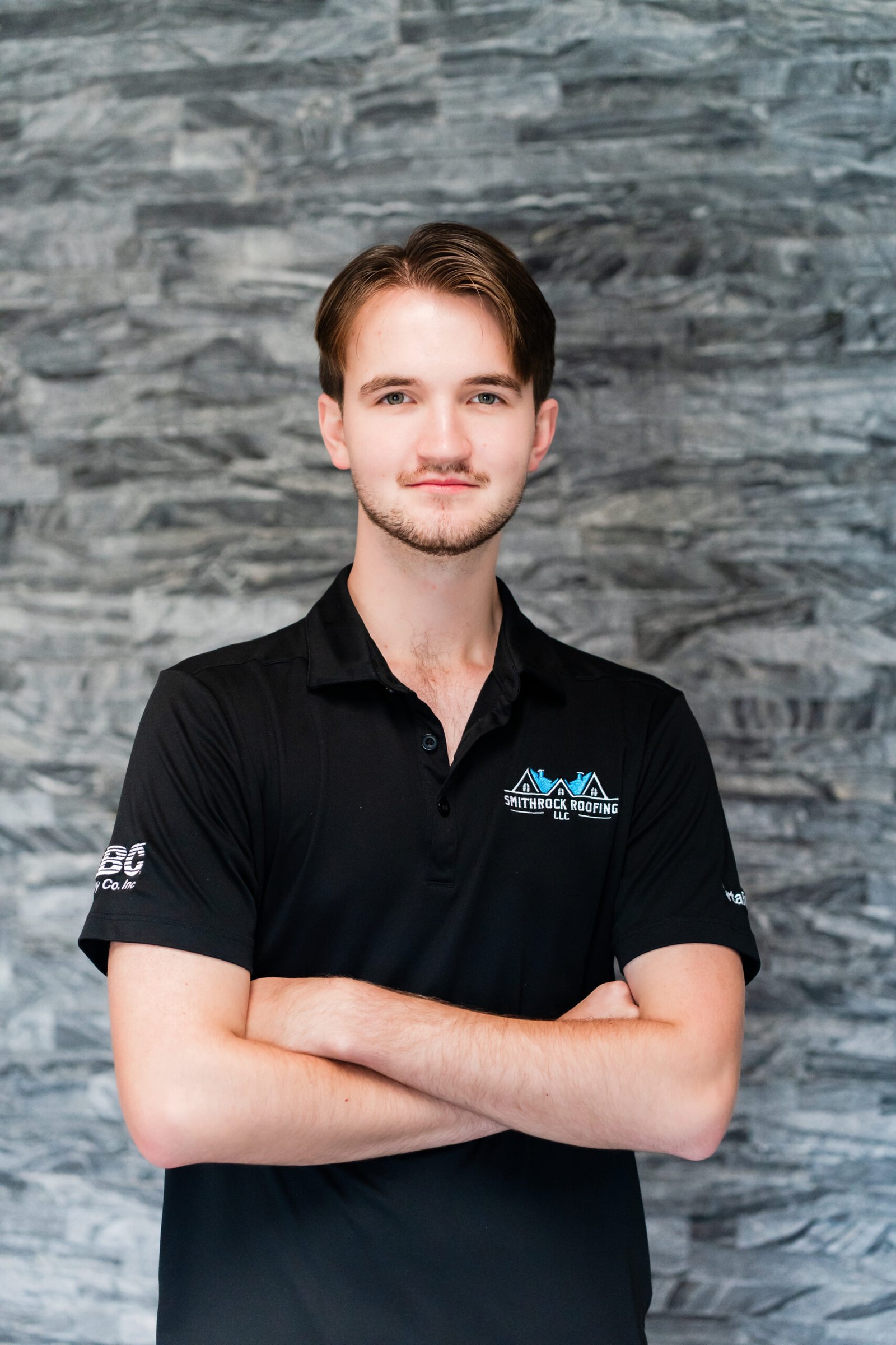 Taylor Sutphin, Project Advisor at Smithrock Roofing, wearing company gear