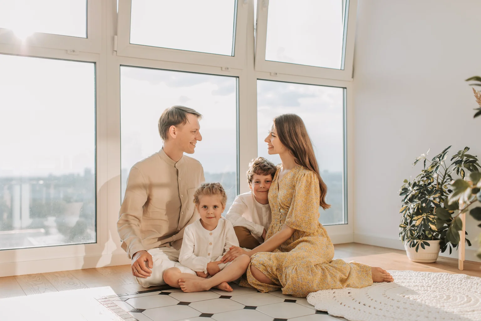 A family comfortably enjoying a sunlit room next to a large, modern energy-efficient window, depicting improved indoor comfort and natural light - energy efficient window upgrades Family relaxing in a bright, sunlit room beside a large modern energy-efficient window upgrade