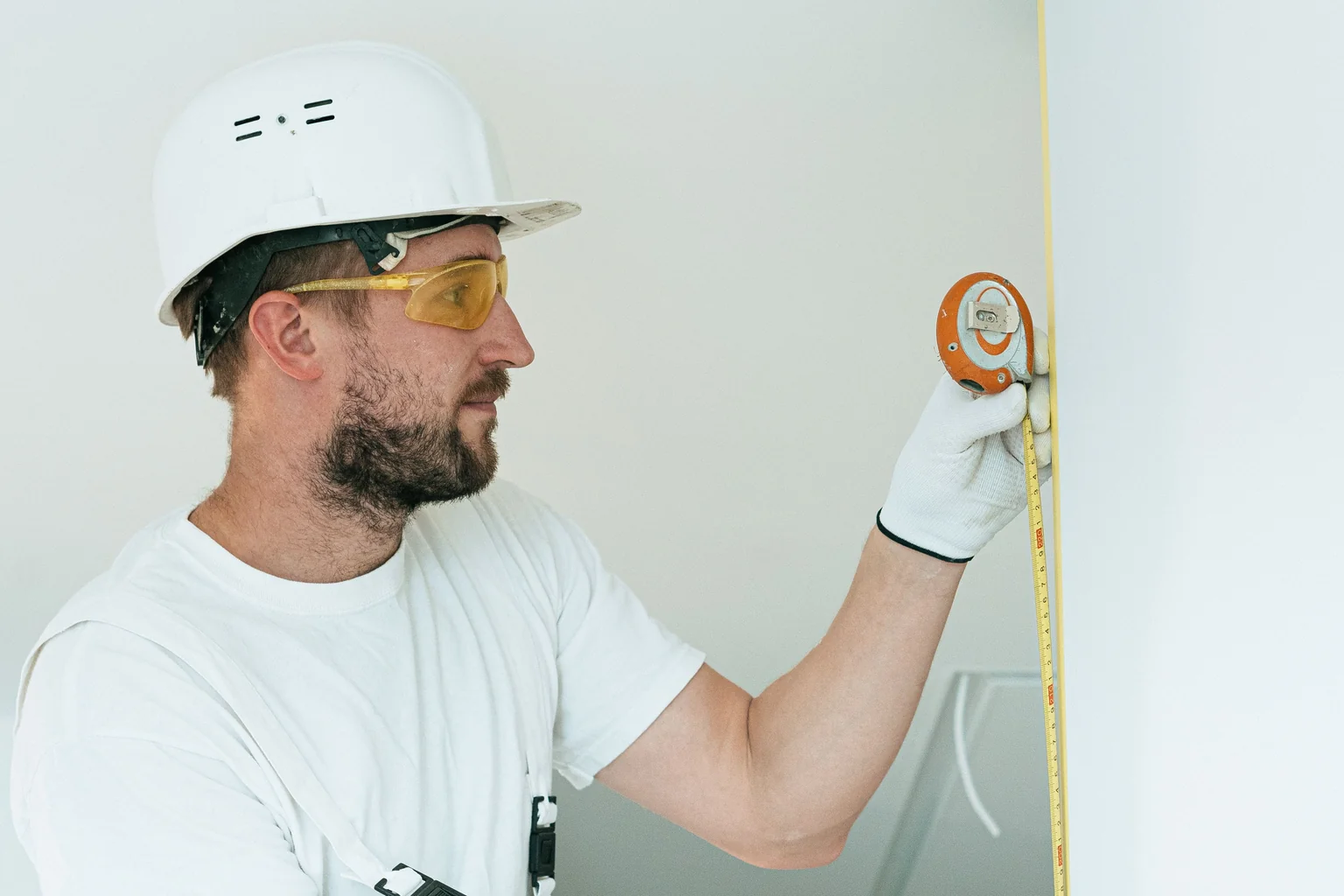 Contractor measuring a window opening - window replacement cost winston salem nc Contractor measuring a window opening - window replacement cost winston salem nc