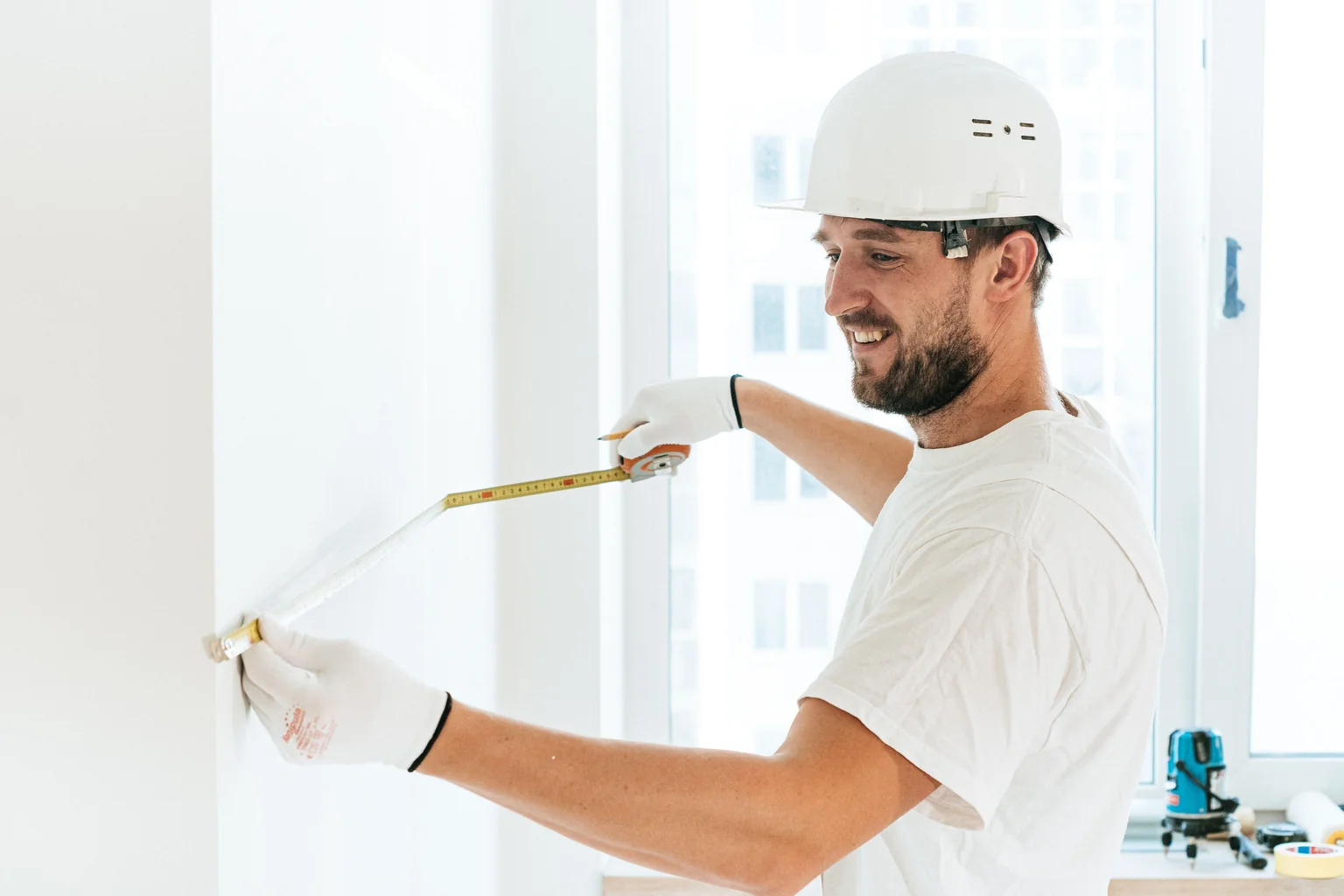 professional installer carefully measuring a window opening - window replacement winston salem professional installer carefully measuring a window opening - window replacement winston salem