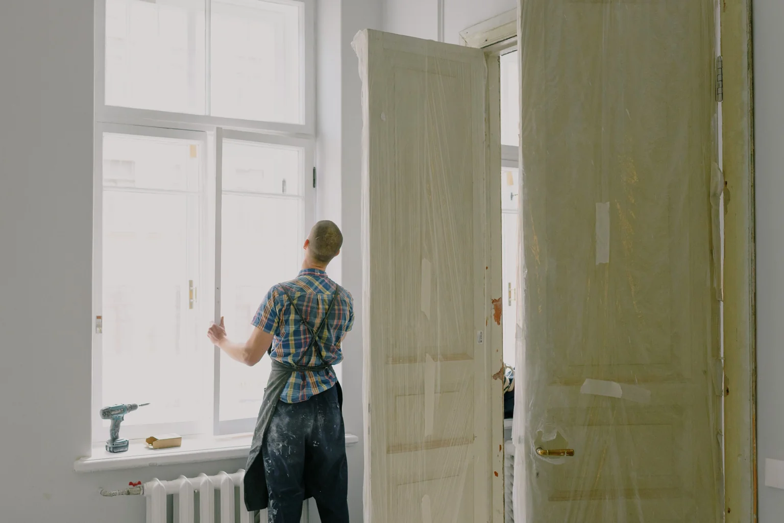 Professional installers working on window replacement in mild weather conditions - best time to replace windows