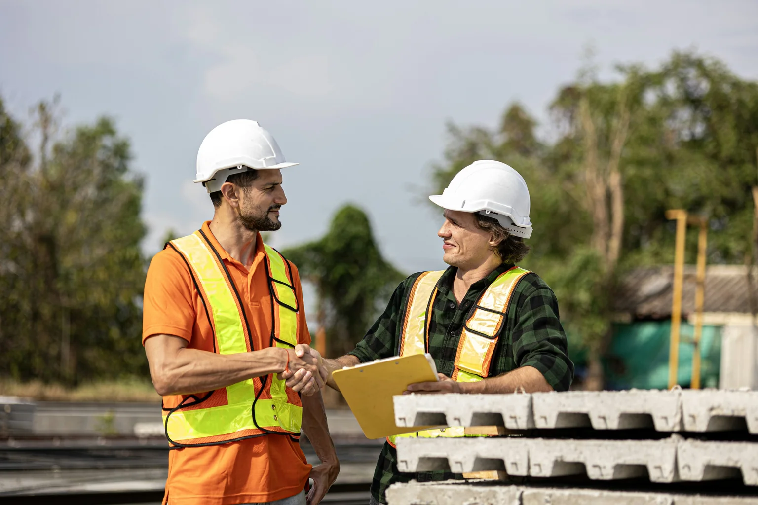 A homeowner shaking hands with a professional-looking roofing contractor - professional roofing company near me A homeowner shaking hands with a professional-looking roofing contractor - professional roofing company near me